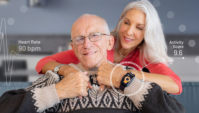 Elderly man wears the Tempo watch while being hugged by his daughter.