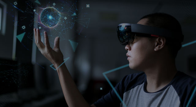 Man with hololens glasses holds a virtual reality ball